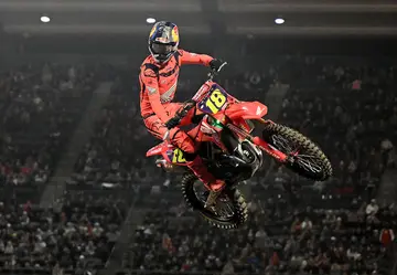 A motocross athlete celebrates after winning the 450SX main event