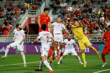 China's Zhu Chenjie heads the ball in but the goal was disallowed