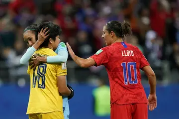 Sukanya Chor Charoenying is consoled by a teammate and the USA's Carli Lloyd, who  'told me to keep going and not quit. That made me feel really good'.