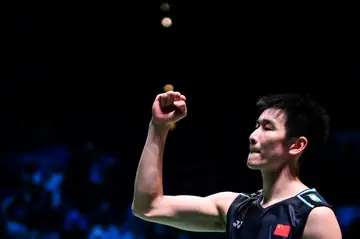 China's Li Shi Feng celebrates after defeating compatriot Shi Yu Qi in the men's singles final of badminton's All England Open