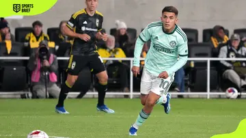 Thiago Almada runs with the ball during a match