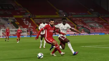 Mohamed Salah and Bukayo Saka in action during the Carabao Cup fourth round match between Liverpool and Arsenal at Anfield. Photo by John Powell.