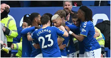 Everton's Brazilian striker Richarlison celebrates with teammates after scoring the opening goal of the English Premier League football match between Everton and Chelsea. Photo by Paul ELLIS.