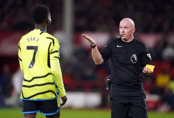 Referee, Simon Hooper with Arsenal's Bukayo Saka during a Premier League match at the City Ground on January 30, 2024.