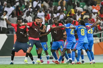 Yoane Wissa (3R) celebrates scoring for the Democratic Republic of Congo against Guinea with teammates.