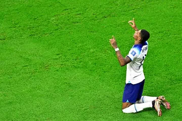 Marcus Rashford celebrates scoring England's first goal against Wales at the World Cup