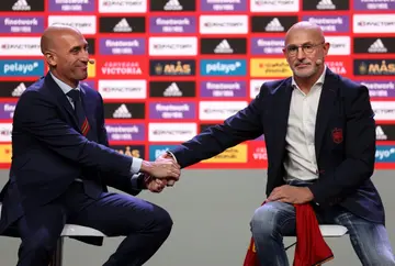 Spain's new coach Luis de la Fuente (R) shakes hands with Spanish federation president Luis Rubiales (L) after his presentation
