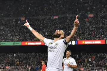 Real Madrid's French forward Karim Benzema celebrates after scoring his team's fourth goal against Barcelona at Camp Nou