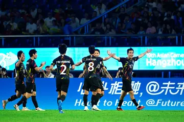 South Korea's Song Min-kyu (R) celebrates after scoring against China