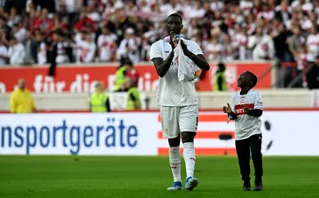 Bundesliga history maker Serhou Guirassy celebrates with his son after Stuttgart defeated Wolfsburg.