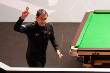 Ronnie O'Sullivan of England celebrates victory against Jackson Page of Wales in their first round match at Crucible Theatre in Sheffield, England
