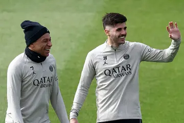 Kylian Mbappe (L) with teammate Lucas Beraldo on the eve of PSG's Champions League clash with Barcelona
