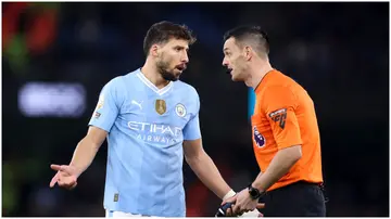 Manchester City's Ruben Dias speaks to referee, Andy Madley, during the Premier League game against Chelsea FC.