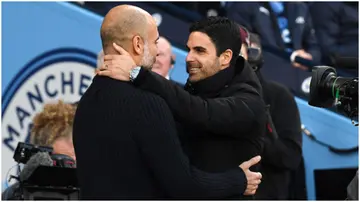 Mikel Arteta embraces Pep Guardiola prior to the Premier League match between Manchester City and Arsenal FC at Etihad Stadium. Photo by David Price.