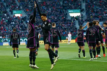 On target: Bayern Munich's Alphonso Davies (left) celebrates scoring his team's second goal