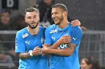 Jonathan Clauss (L) and Luis Suarez celebrate Marseille's opener against Angers
