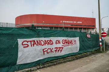 A banner makes clear what fans think about 777 Partners outside Standard Liege's stadium in Belgium