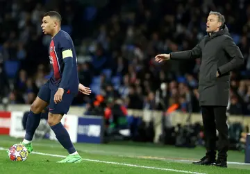 Luis Enrique (R) standing behind Kylian Mbappe (L) during PSG's Champions League last 16 second-leg match at Real Sociedad in March