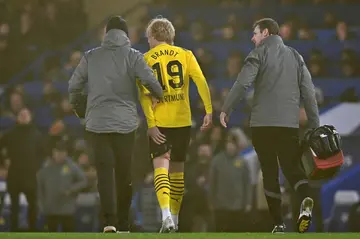 Dortmund' midfielder Julian Brandt holds his leg as he leaves the pitch during the match against Chelsea. He will miss at least two games with a torn muscle