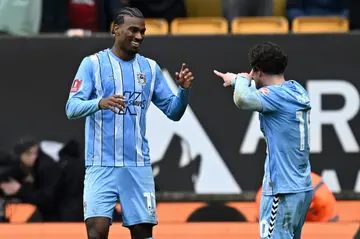 Coventry City's USA striker Haji Wright, left, celebrates with teammate Callum O'Hare after grabbing the winner in their FA Cup quarter-final against Wolverhampton Wanderers