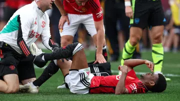 Amad Diallo lies injured during the USA summer friendly game between Arsenal and Manchester United at MetLife Stadium. Photo by Matthew Ashton.