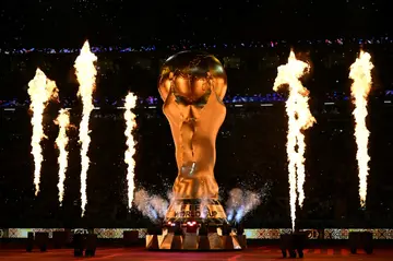 Fireworks explode around a replica of the World Cup trophy during the opening ceremony in Qatar