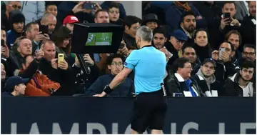 A referee reviewing VAR during a match. Photo: Getty Images.