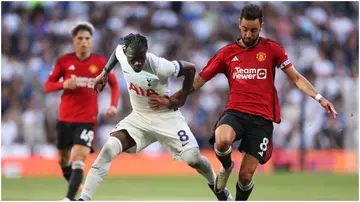 Yves Bissouma battles for possession with Bruno Fernandes during the Premier League match between Tottenham Hotspur and Manchester United. Photo by Julian Finney.