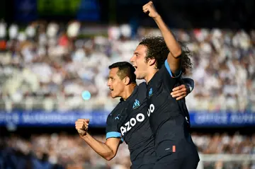 Alexis Sanchez (L) celebrates with Matteo Guendouzi after scoring Marseille's second goal in their win at Auxerre