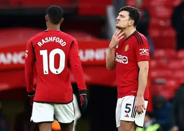 Manchester United's Marcus Rashford (L) and Harry Maguire (R) after their defeat against Fulham