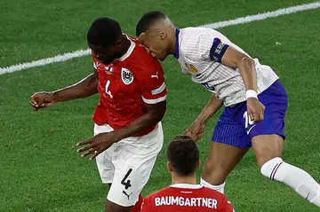 Kylian Mbappe collides with Austria's Kevin Danso during the France vs Austria match.