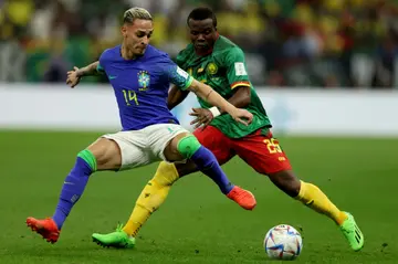 Cameroon defender Nouhou Tolo (R) fights for the ball during a 2022 World Cup clash with Brazil in Qatar