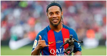 Former Barcelona forward Ronaldinho poses with the trophy for the best player after a charity football match between Barcelona Legends vs Manchester United Legends at the Camp Nou. Photo: Pau Barrena.