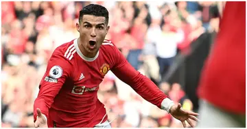 Cristiano Ronaldo celebrates after scoring his third goal during the English Premier League football match between Manchester United and Norwich City at Old Trafford. Photo by Paul ELLIS.