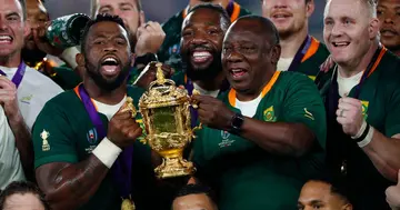 Cyril Ramaphosa lifting the Rugby World Cup trophy alongside Siya Kolisi.