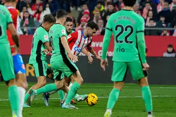 Girona's Spanish midfielder Ivan Martin (C) found space and then the top corner to snatch his team a remarkable win over Atletico Madrid