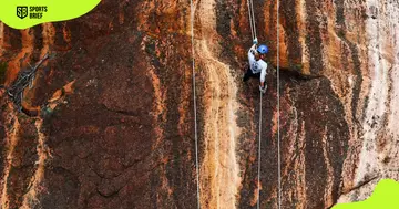 Elina Ussher pictured abseiling a rock wall in Tasmania, Australia.