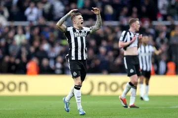 Newcastle United players celebrate after scoring a goal during a Premier League match