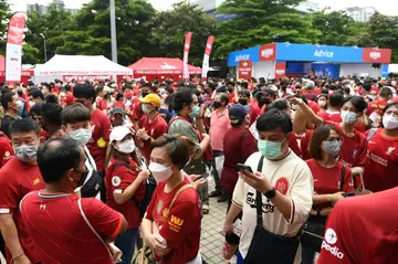 Fans wait outside Rajamangala National Stadium ahead of the  match between English Premier League teams Manchester United and Liverpool