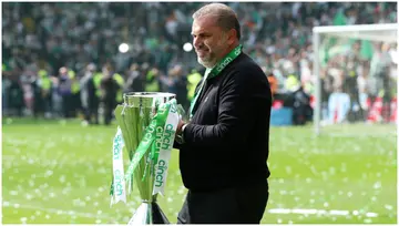 Angelos Postecoglou lifts The Cinch Premiership trophy after the Scottish Premiership match between Celtic and Motherwell. Photo by Ian MacNicol.