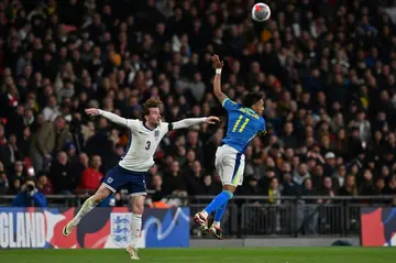 England defender Ben Chilwell (L) in action against Brazil midfielder Raphinha (R) during a recent friendly international at Wembley