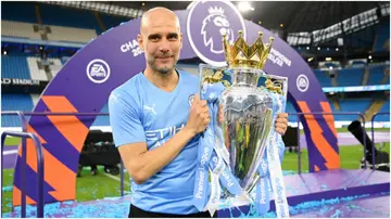 Pep Guardiola celebrates with the Premier League trophy after their side finished the season as Premier League champions in 2022. Photo by Michael Regan.