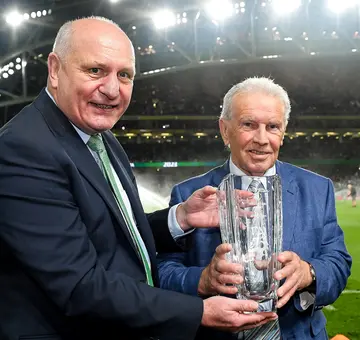 Gerry McAnaney, left, presents the Hall of Fame award to John Giles