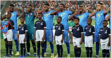 DR Congo players cover their mouths with their handsduring the national anthem before their AFCON semi-final against Ivory Coast.