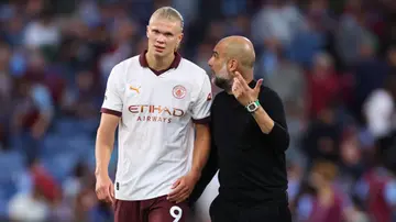 Pep Guardiola reacts towards Erling Haaland during the Premier League match between Burnley FC and Manchester City at Turf Moor. Photo by Robbie Jay Barratt.