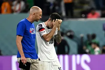 USA coach Gregg Berhalter consoles forward Christian Pulisic after his team bow out of the World Cup