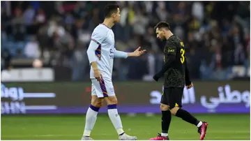 Lionel Messi walks past Cristiano Ronaldo during the Winter Tour 2023 friendly between Paris Saint-Germain and Riyadh XI at King Fahd International Stadium. Photo by Yasser Bakhsh.