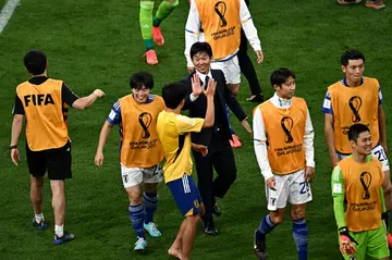 Hajime Moriyasu (C) congratulates his players after their historic win over Germany