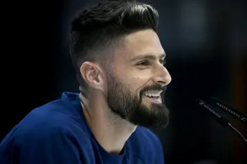 Olivier Giroud smiles as he speaks to reporters in Doha on Tuesday