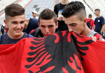 The Albanian flag features a black eagle